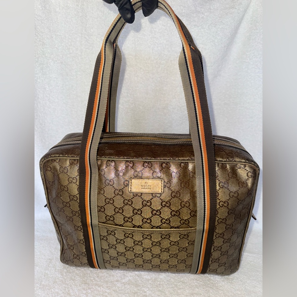 Gucci GG Crystal Coated Canvas in gold and brown color.